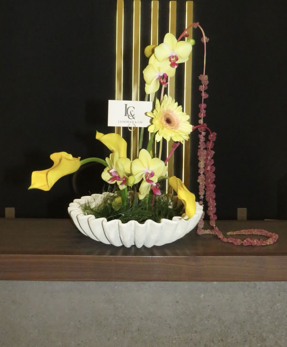 Statement Ikebana arrangement by Lenorah & Co. — orchids, protea and sculptural branch work composed on a kenzan pin frog in a designer vessel.